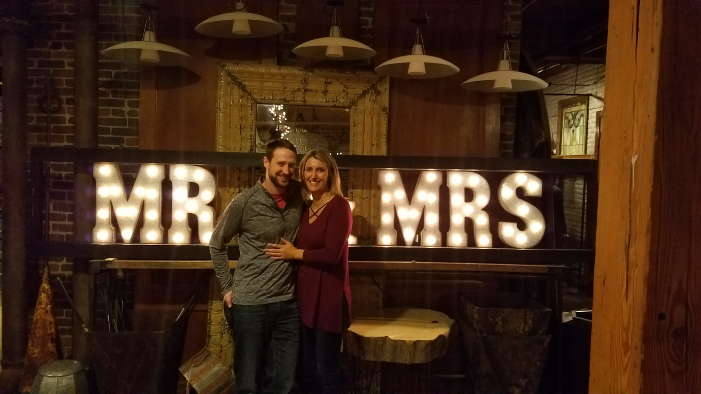 Us standing in front of Mr & Mrs sign