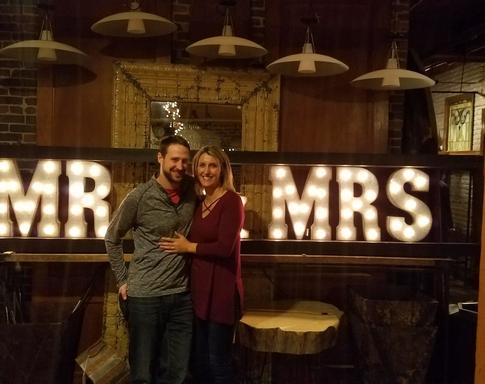 Us standing in front of Mr & Mrs sign