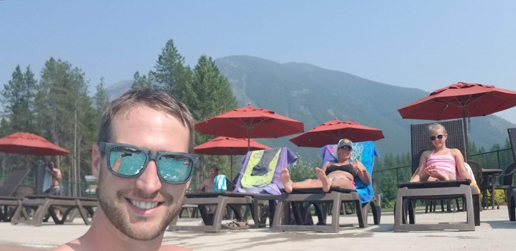Wife and daughter laying by the pool