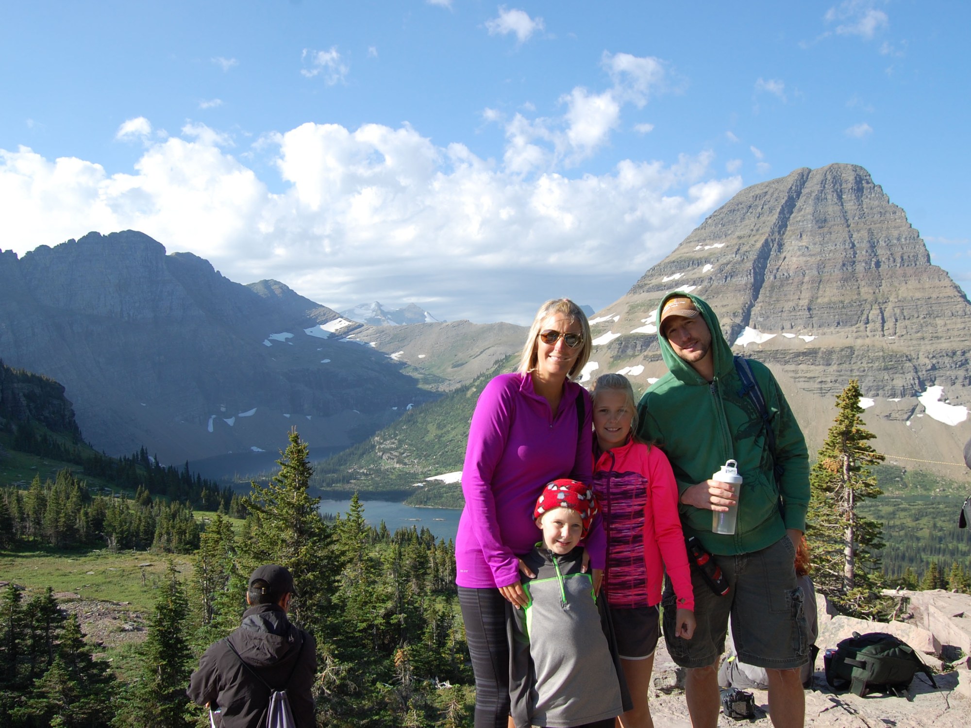 A family photo in front of a grand landscape of Hidden Lake