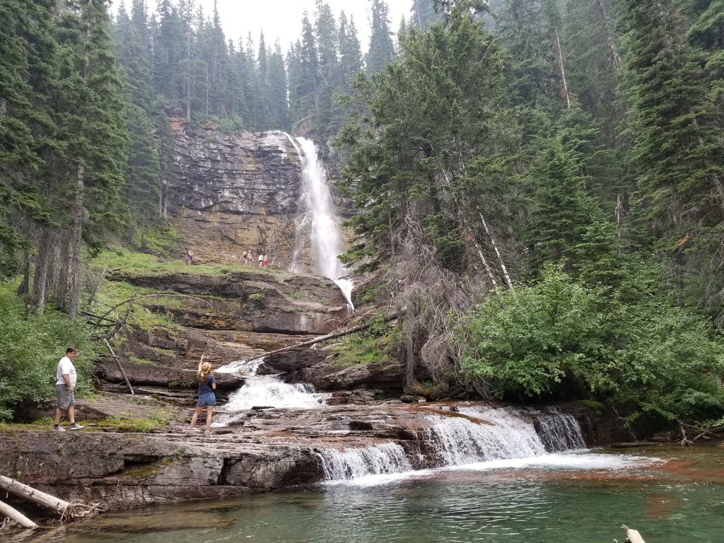 A towering waterfall cascading over rocks
