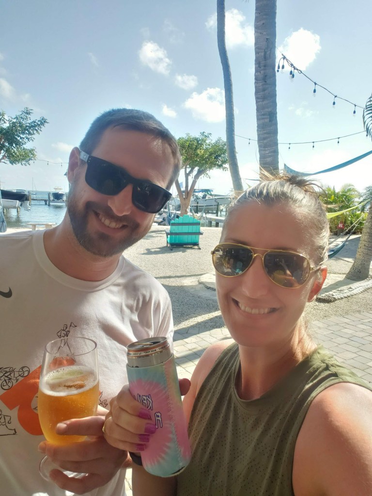 A couple with drinks on the beach