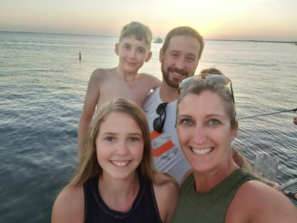 A smiling family at sunset