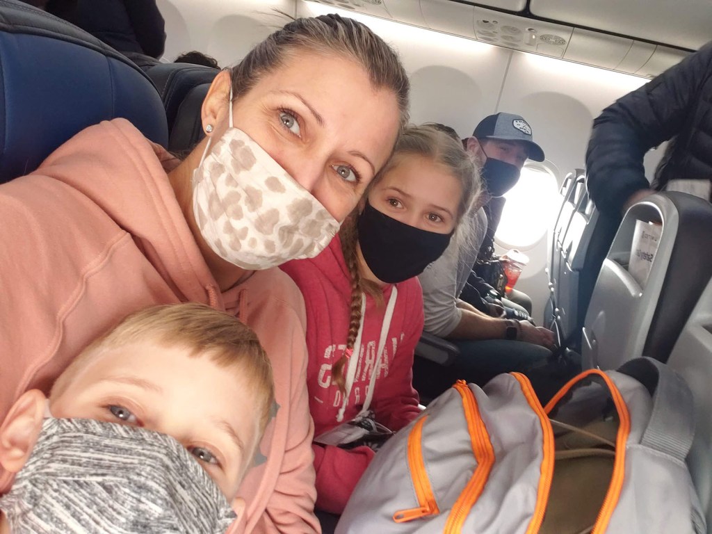 A family on the plane wearing masks