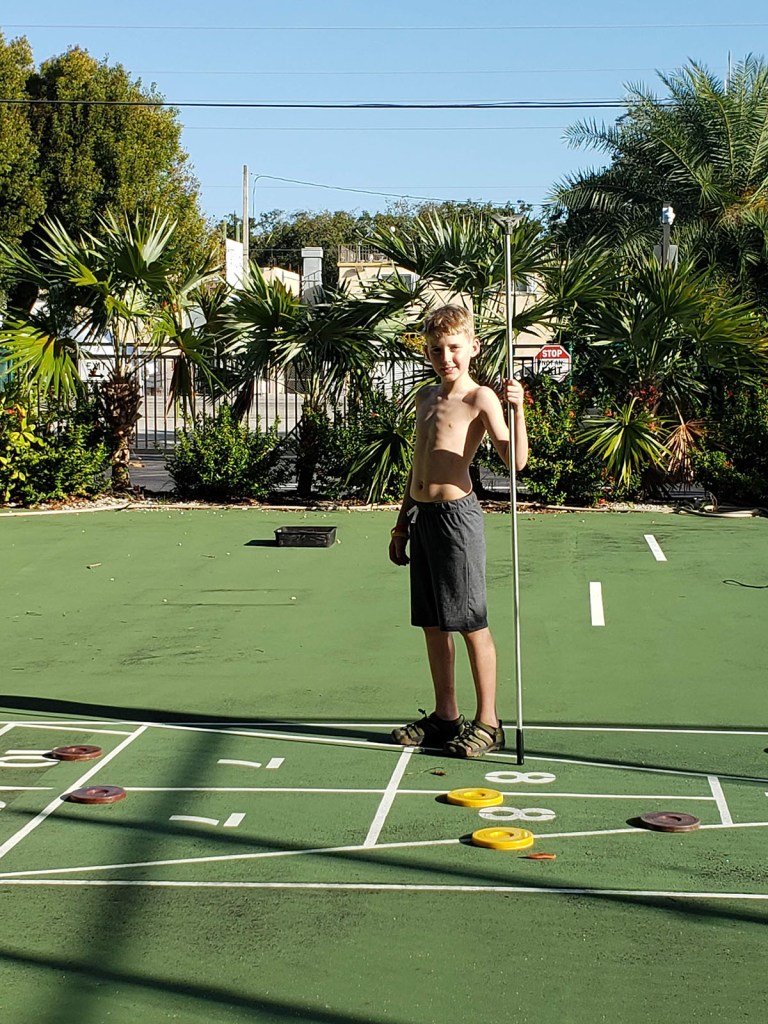 A boy playing shuffleboard