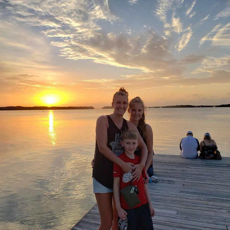 Family in front of a sunset on a dock