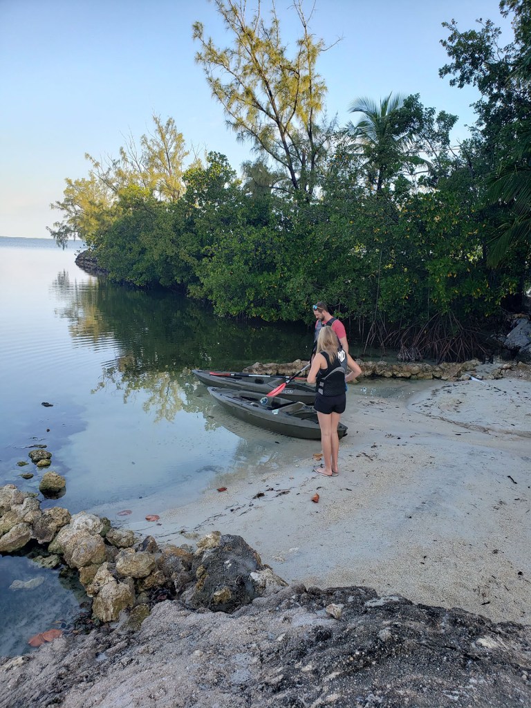 A father and daughter prepping kayaks