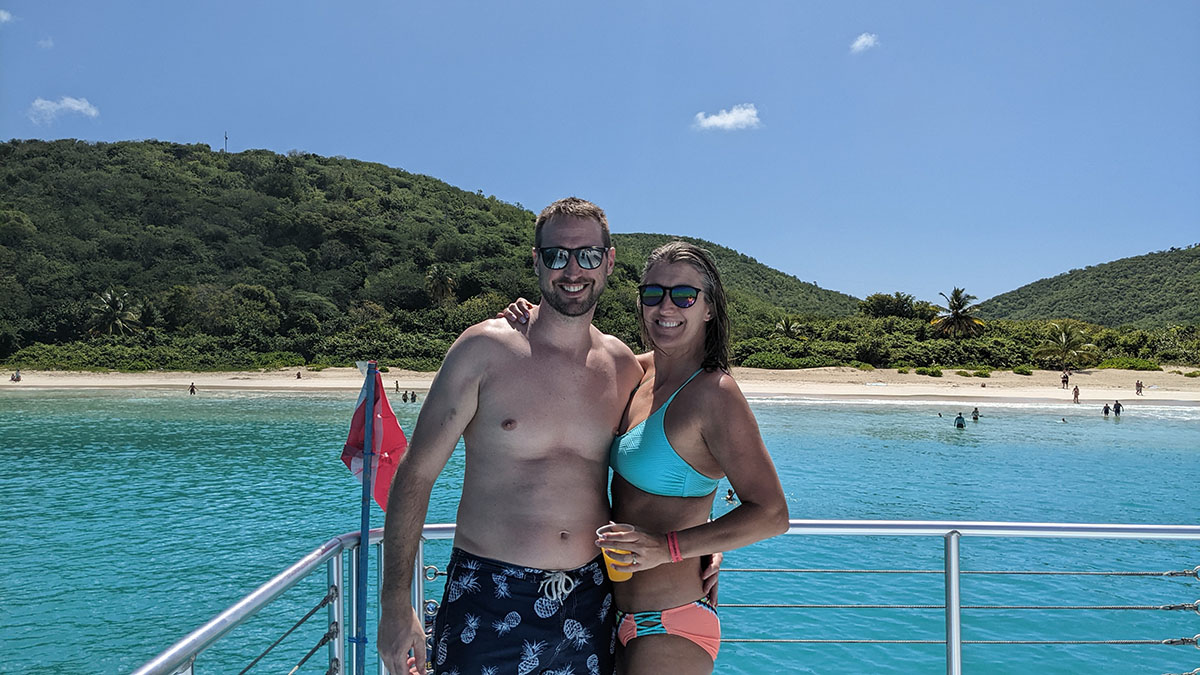 A couple embraces at Flamenco Beach from a boat