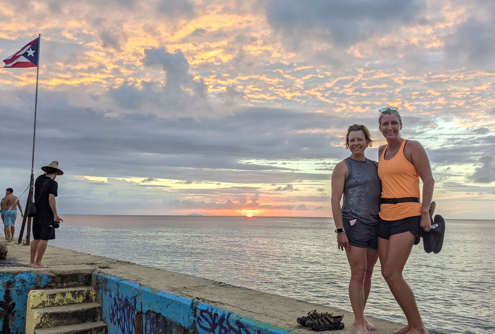 The girls standing on the pier at Crash Boat Beach