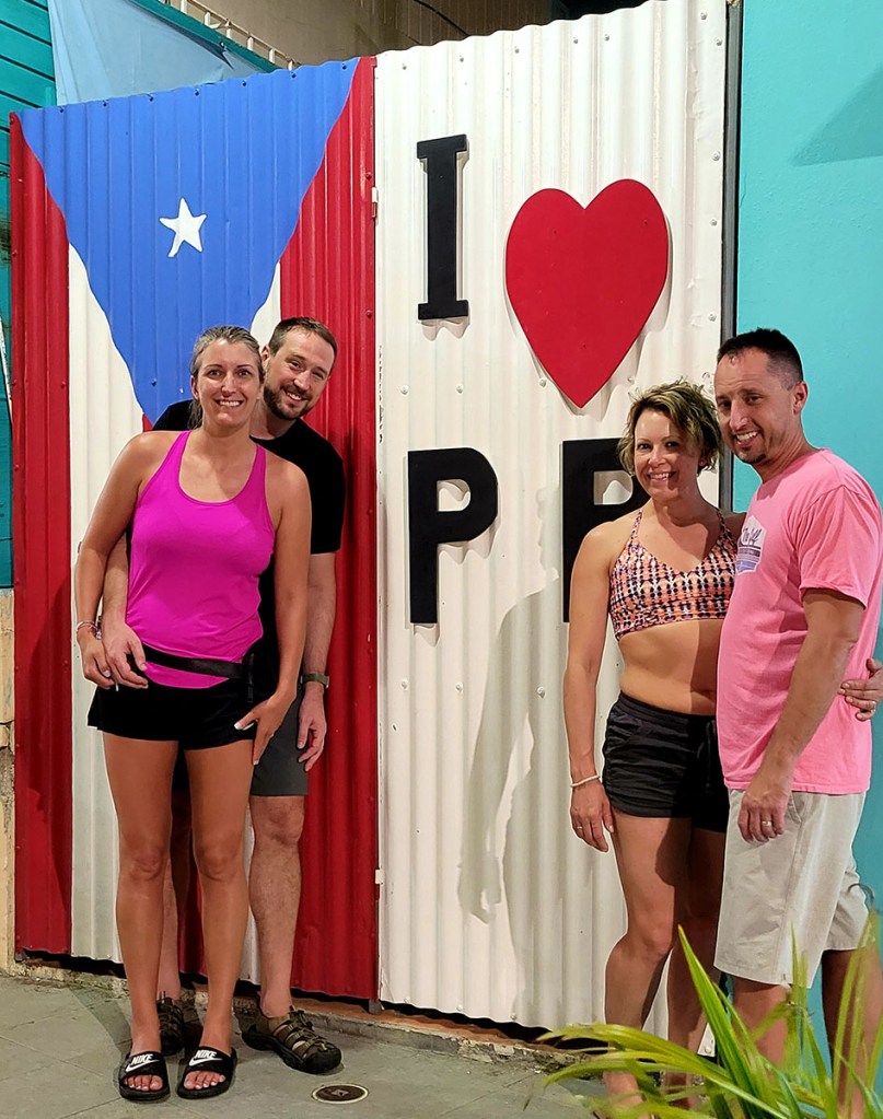 Two couples stand next to a "I heart PR" sign