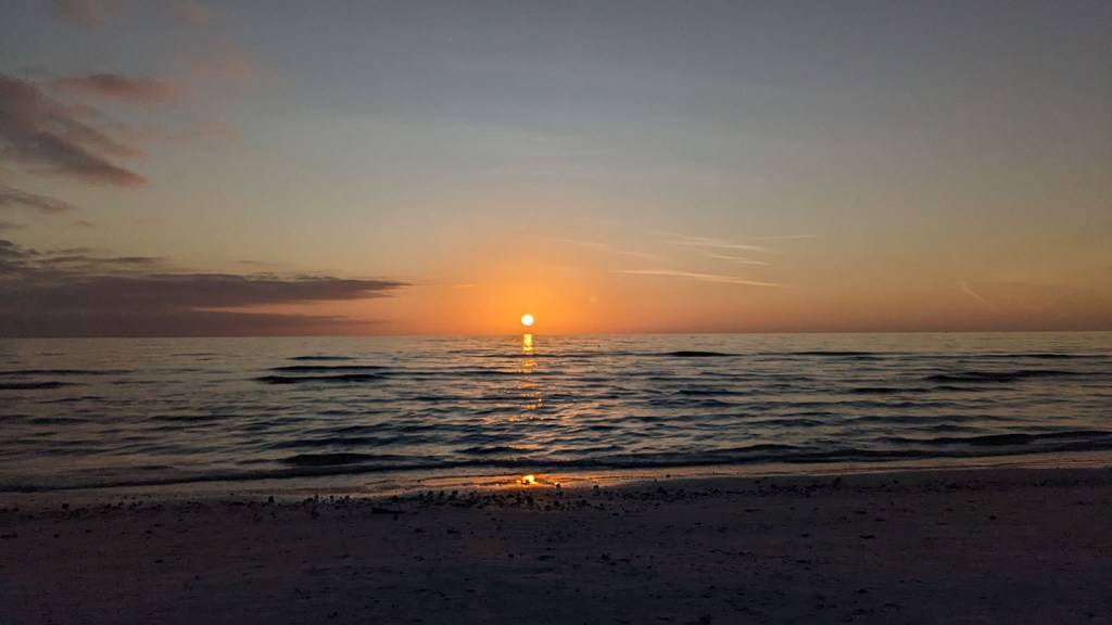 A yellow sphere dropping over the ocean