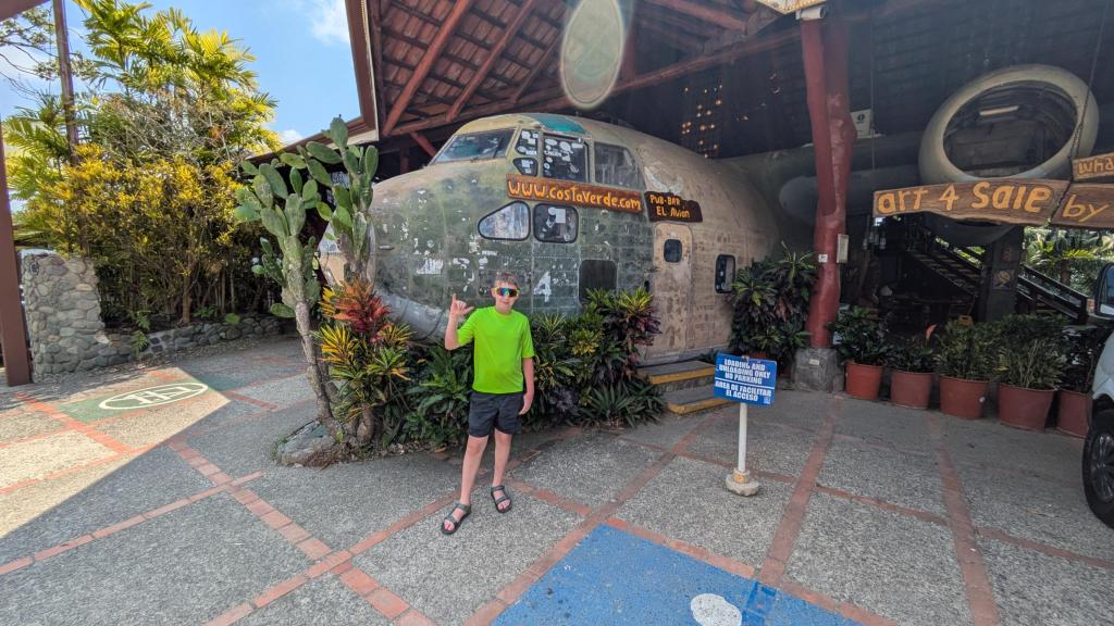 A boy standing in front of a plane turned into a restaurant