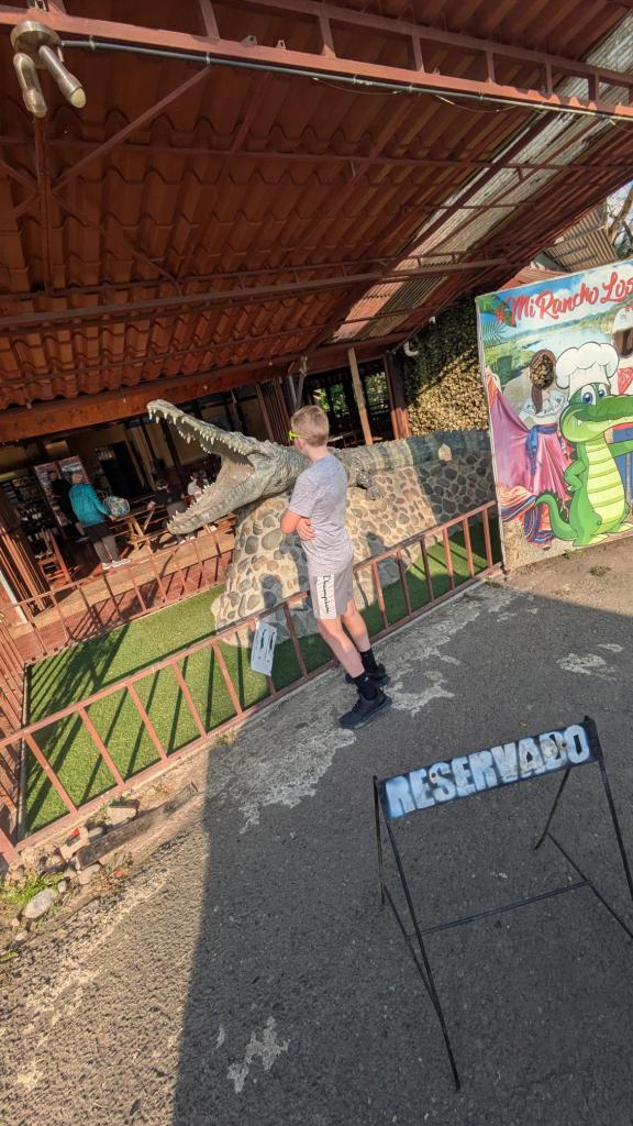 Mattix checking out a croc sculpture at the Soda near crocodile bridge