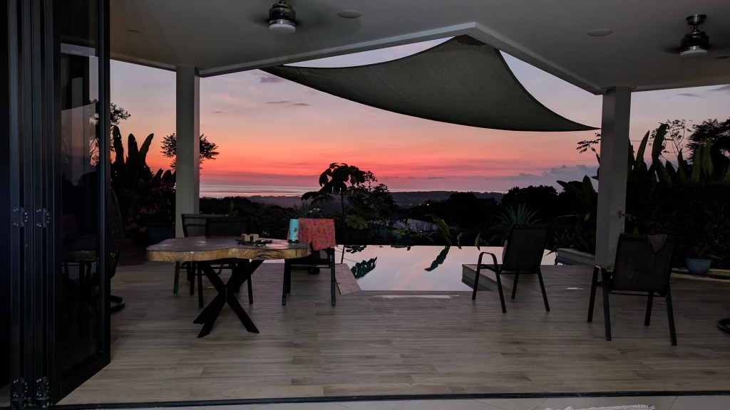 A pink and purple sunset from the patio near the pool.