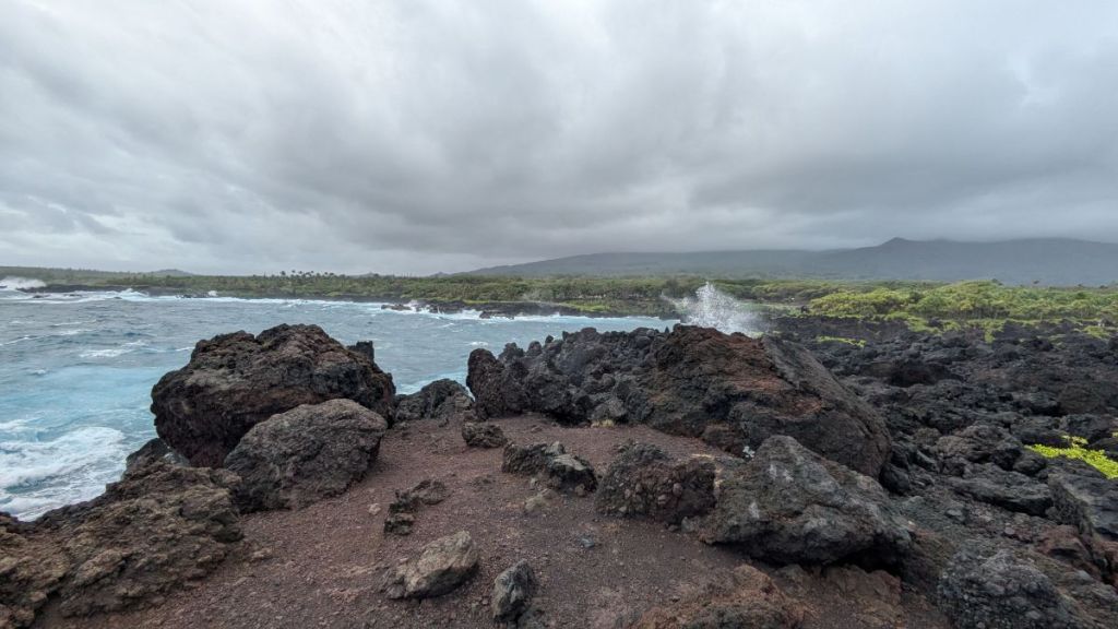 Dark clouds over the black lava rocks atop the Waianapanapa State Park.